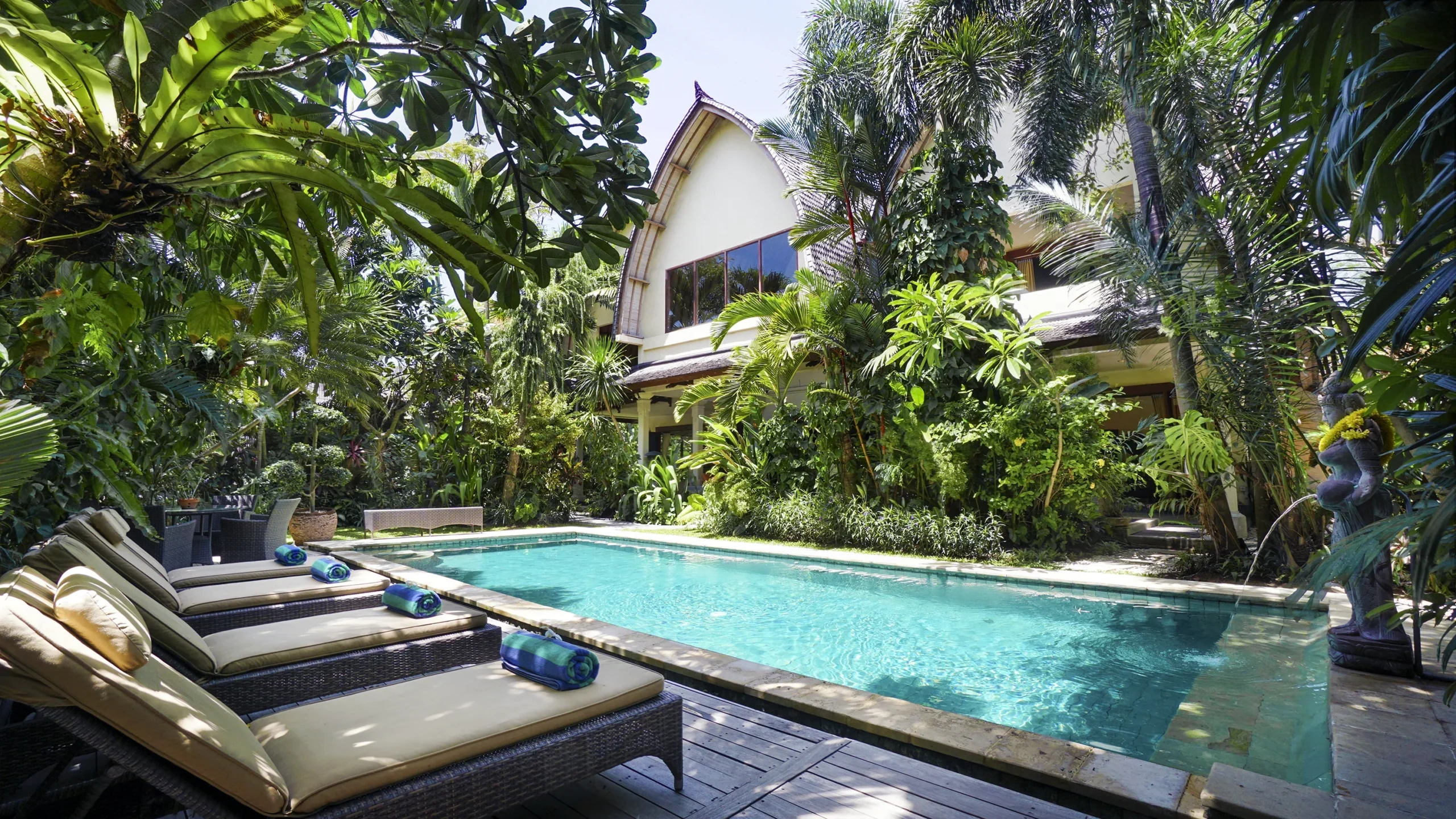 Private swimming pool surrounded by tropical plants at Villa Bali Maja in Petitenget.