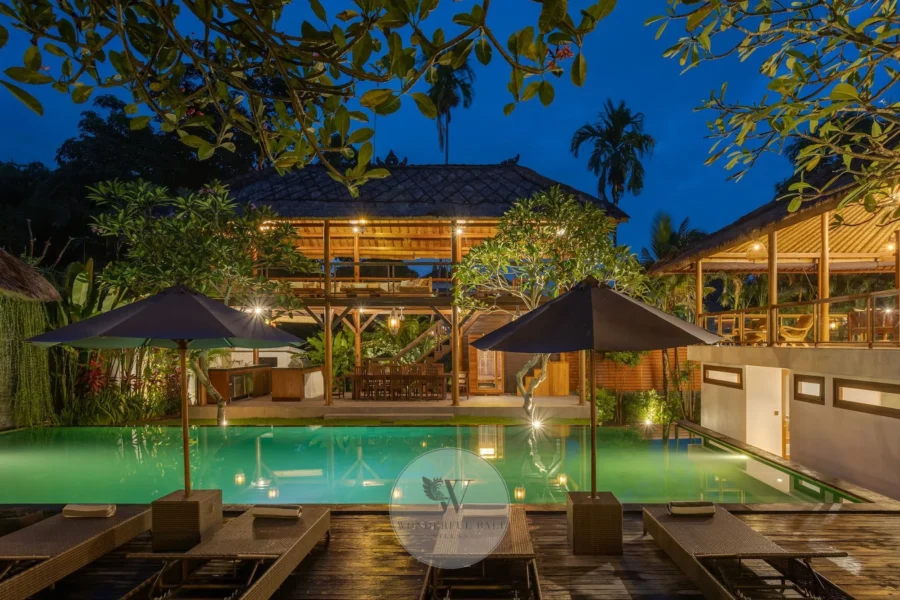 Twilight exterior of a six-bedroom Modern Balinese villa with 18 m pool in Batu Bolong, Canggu