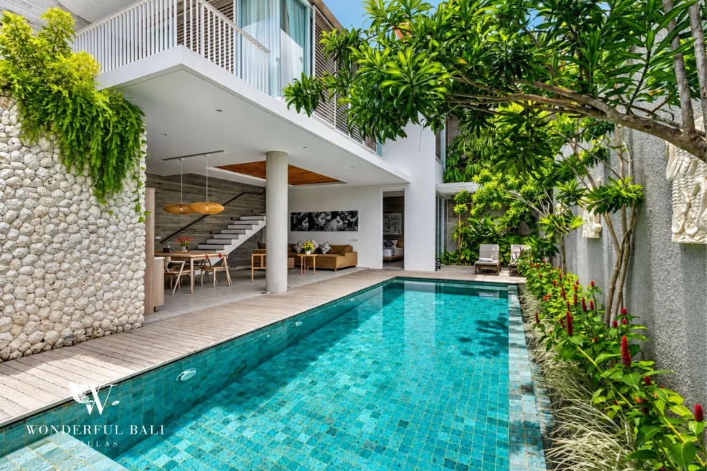 Private pool and tropical garden beside a two-storey villa in Petitenget, Bali
