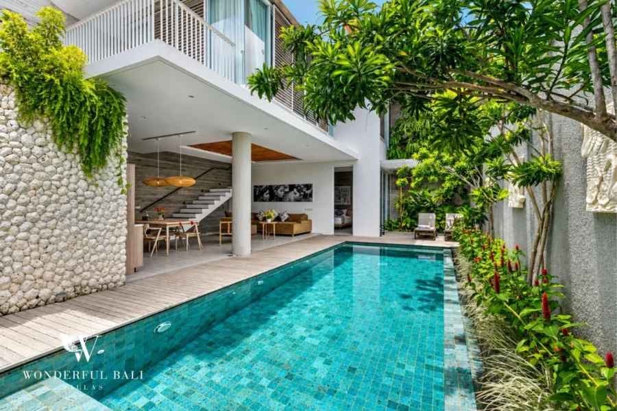 Private pool and tropical garden beside a two-storey villa in Petitenget, Bali