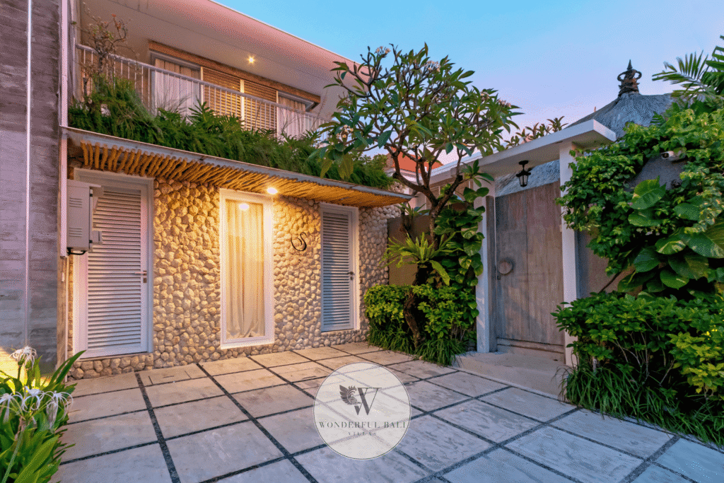 Swan Satu – Covered parking area with tropical garden entrance – Seminyak, Bali