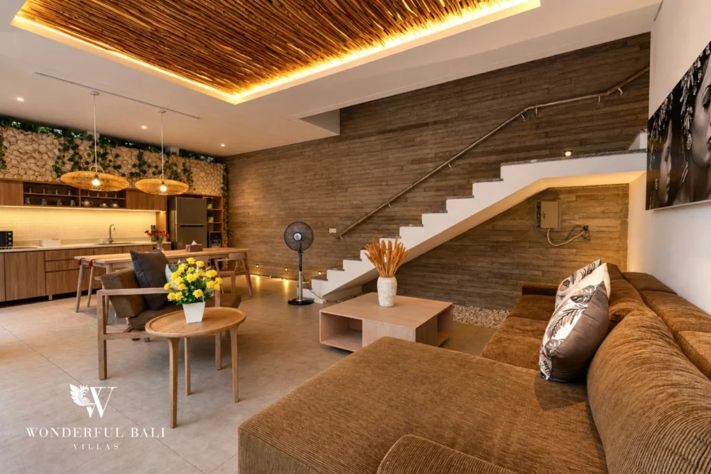 Living lounge with sofa beside the staircase at a villa in Petitenget, Bali