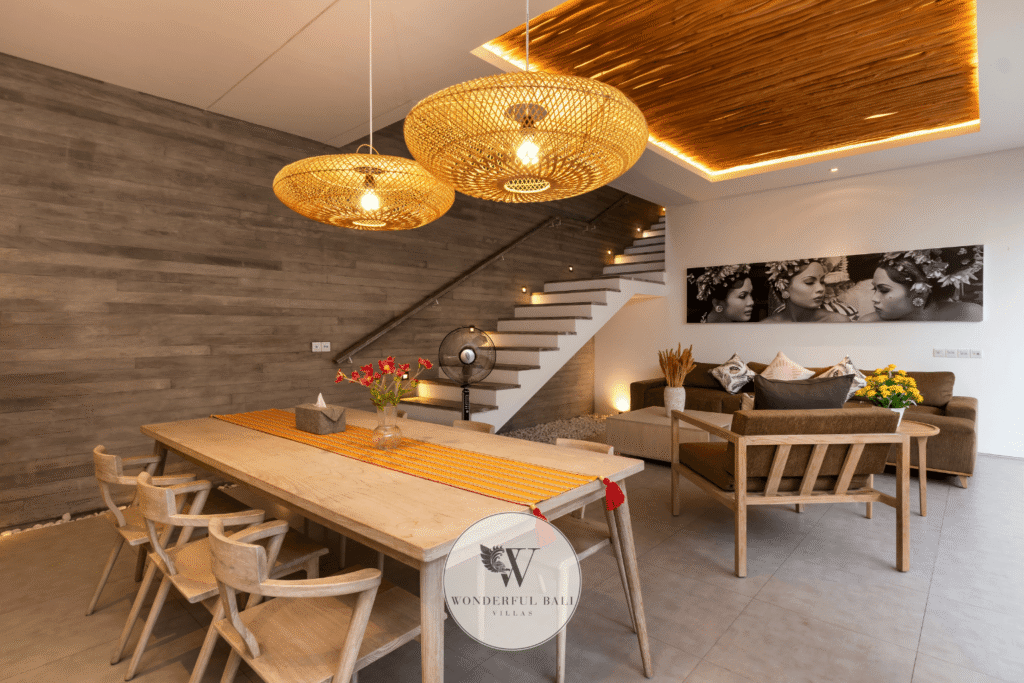 Swan Satu – Open-plan dining and living room with pool view in evening light – Seminyak, Bali