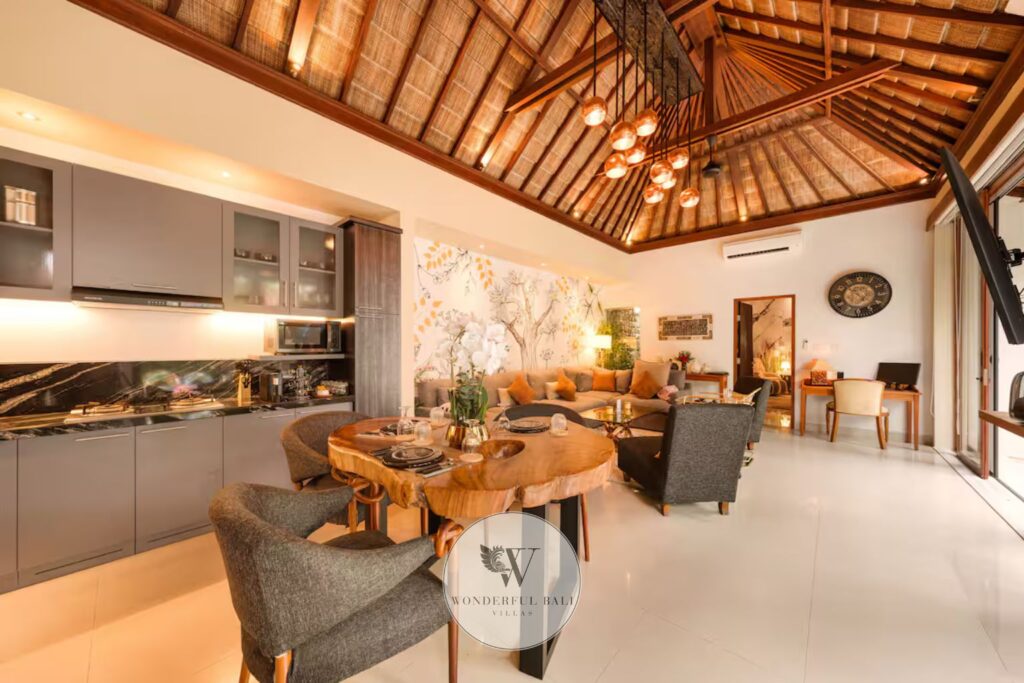 Open-plan dining and living area with high teak ceilings in luxury spa villa, Seminyak Bali