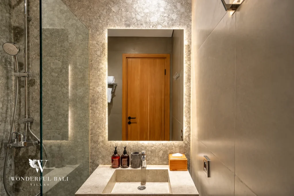 Bathroom with vanity beside the entry door, 1-bedroom modern studio apartment in Canggu, Bali