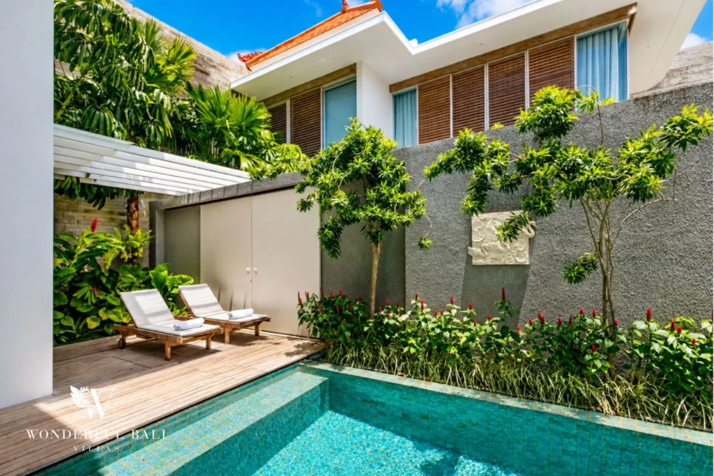 Private pool with sun loungers and garden at a villa in Petitenget, Bali
