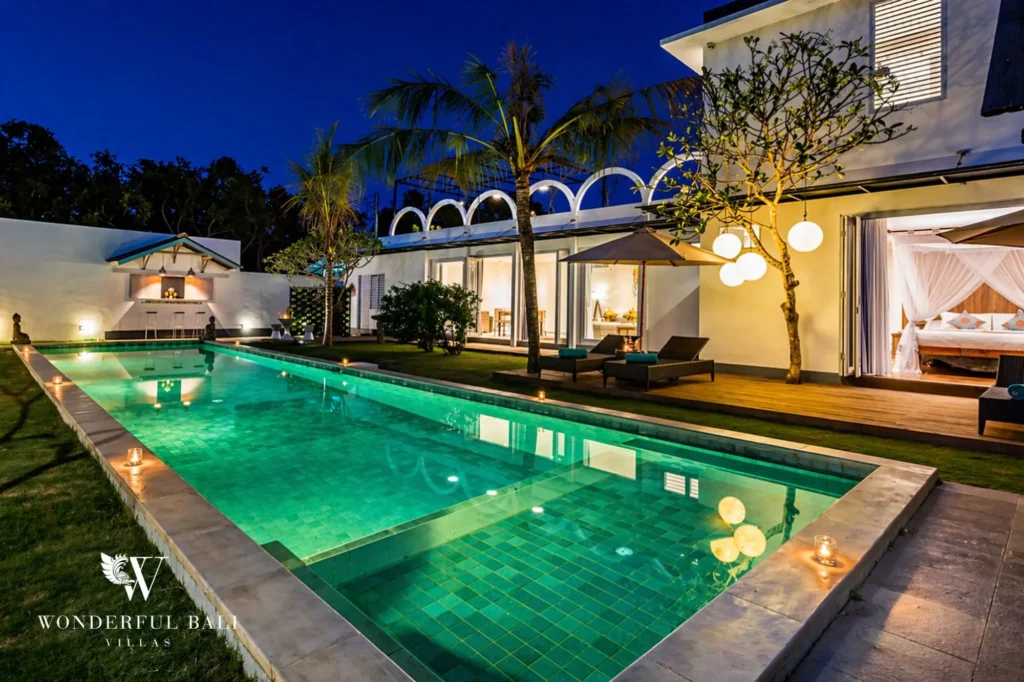 Private pool lit at night with backdrop of illuminated arches, Villa Hasian — 5-bedroom villa in Jimbaran