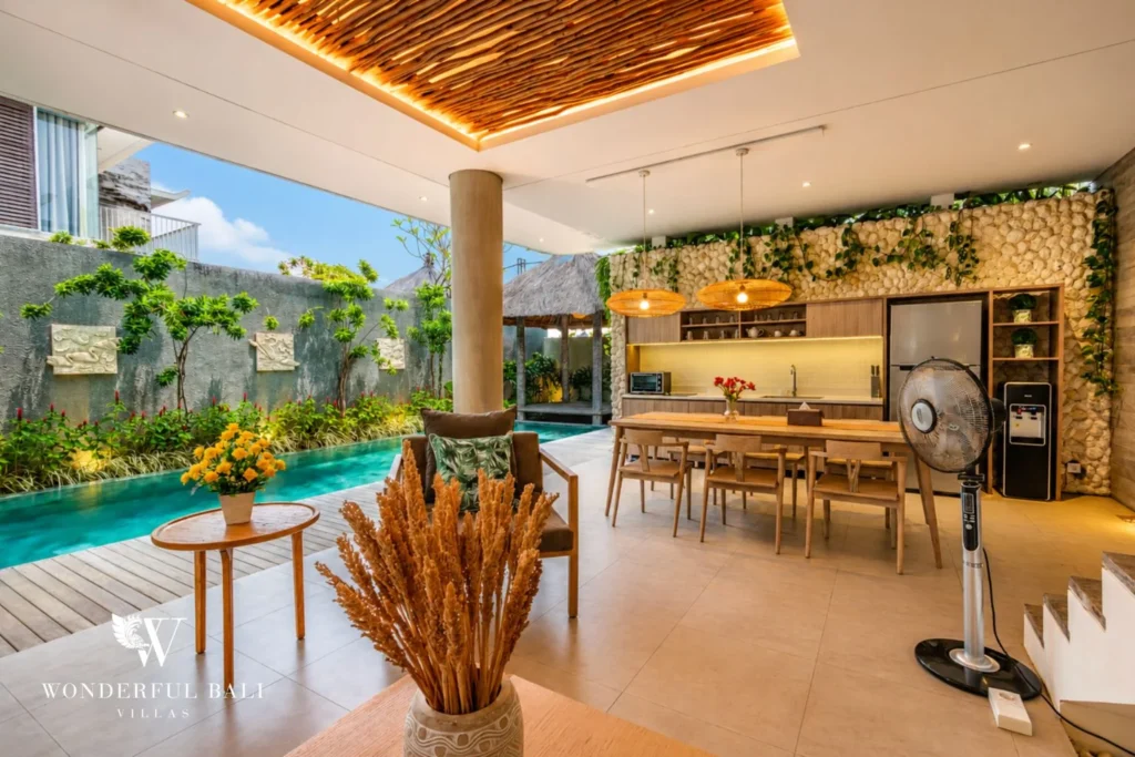 Open kitchen, bar and dining with pool view at a villa in Petitenget, Bali