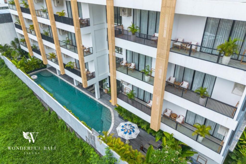 Aerial view of a modern serviced apartment building with long pool in Canggu, Bali