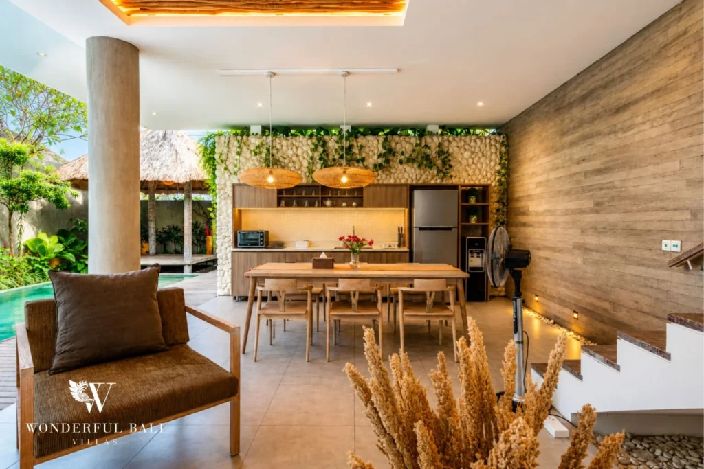 Open kitchen and dining with green wall at a villa in Petitenget, Bali