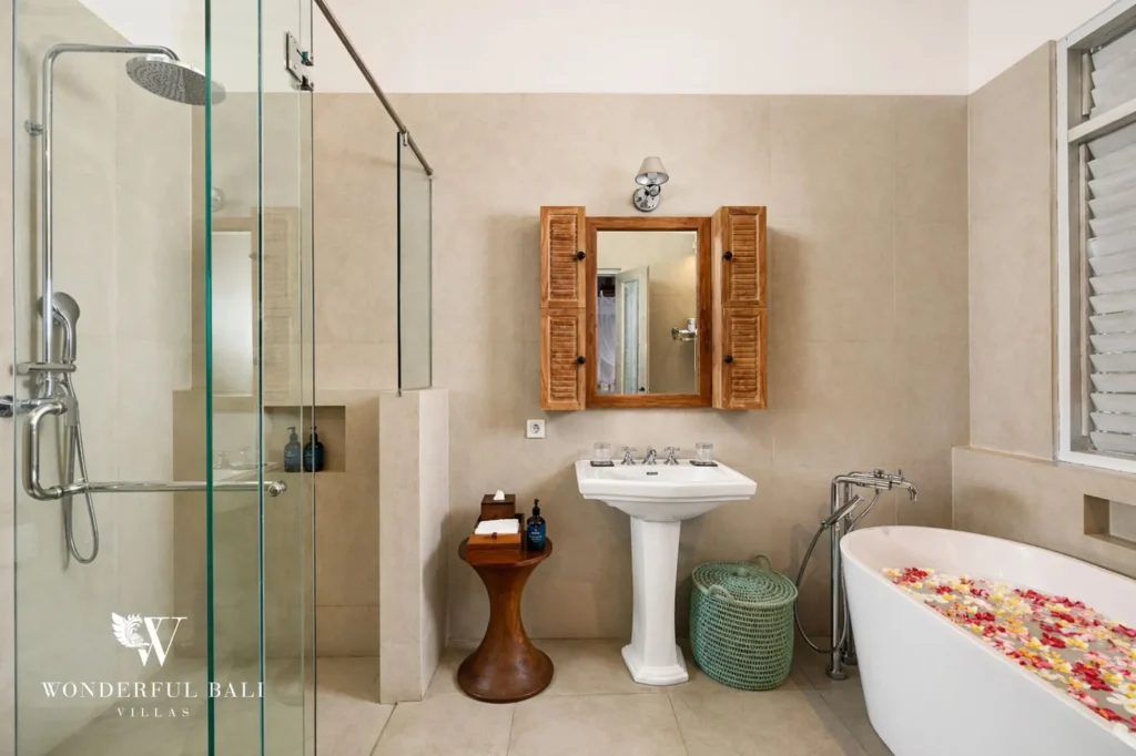 Ensuite bathroom with glass-walled shower and freestanding bathtub, Villa Hasian in Jimbaran