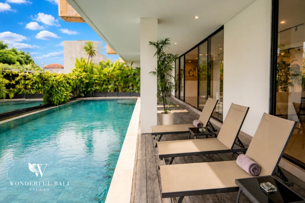 Shared swimming pool with sun loungers, modern serviced apartment in Canggu, Bali