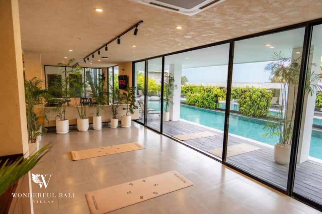 Shared yoga and wellness studio overlooking the pool, modern apartment building in Canggu