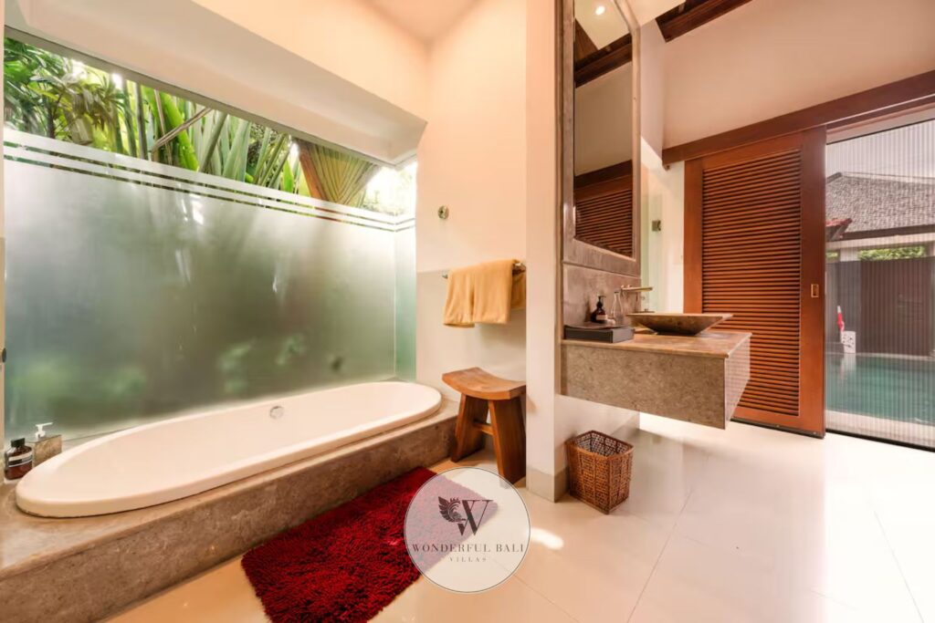 Freestanding soaking bathtub with spa-grade amenities in luxury villa, Seminyak Bali