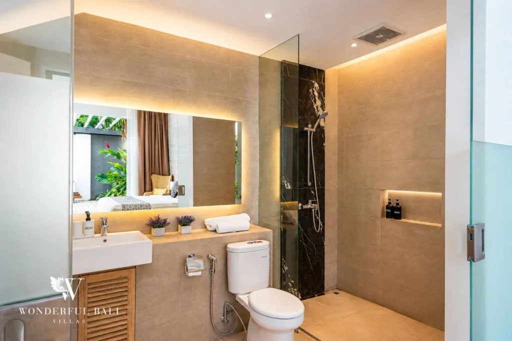 Ensuite bathroom with glass shower at a villa in Petitenget, Bali