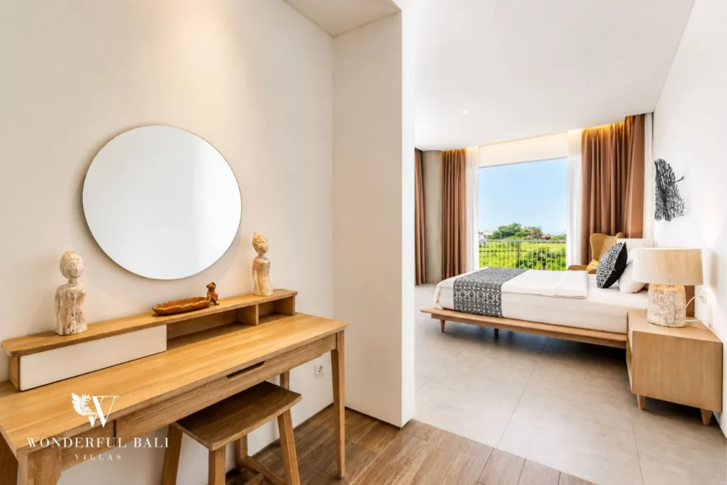 Bedroom with round mirror and vanity at a villa in Petitenget, Bali