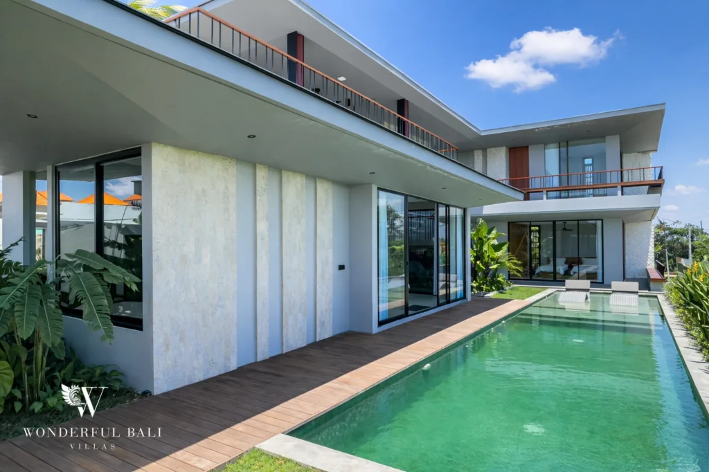 Outdoor pool and villa exterior, modern four-bedroom property in Pererenan