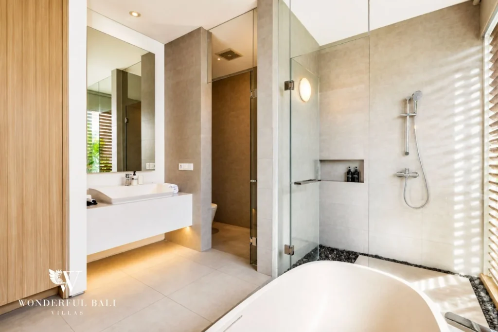 Ensuite bathroom with walk-in shower at a villa in Petitenget, Bali