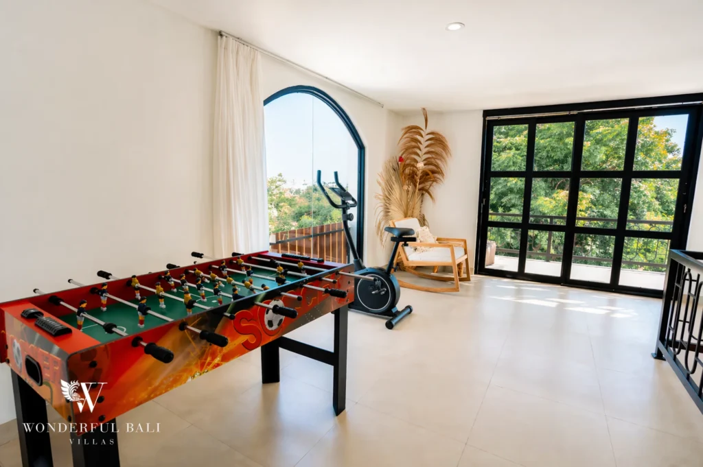 Second-floor indoor play area with mini-soccer and spinning bike, 3-bedroom villa in Ungasan, Bukit