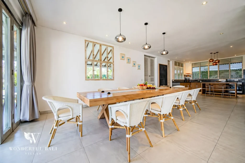 Long wooden dining table with woven chairs seating around twelve, Villa Hasian in Jimbaran