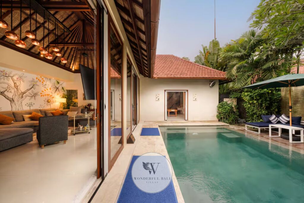 Open-plan living and kitchen area with private pool view at luxury villa, Seminyak Bali