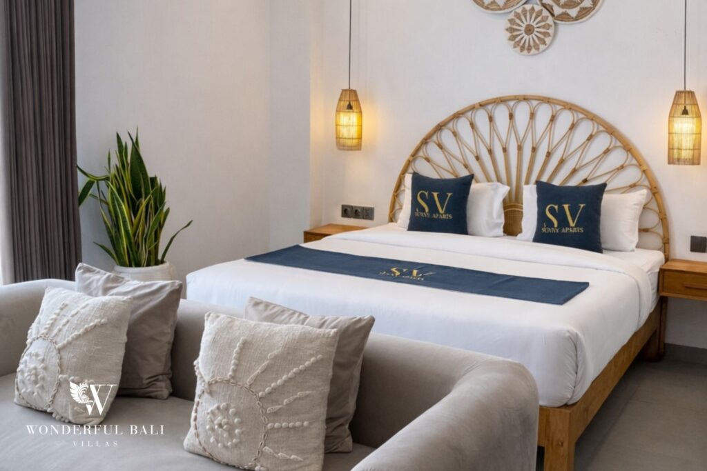 Primary bedroom with rattan headboard and pendant lights, 1-bedroom modern studio apartment in Canggu