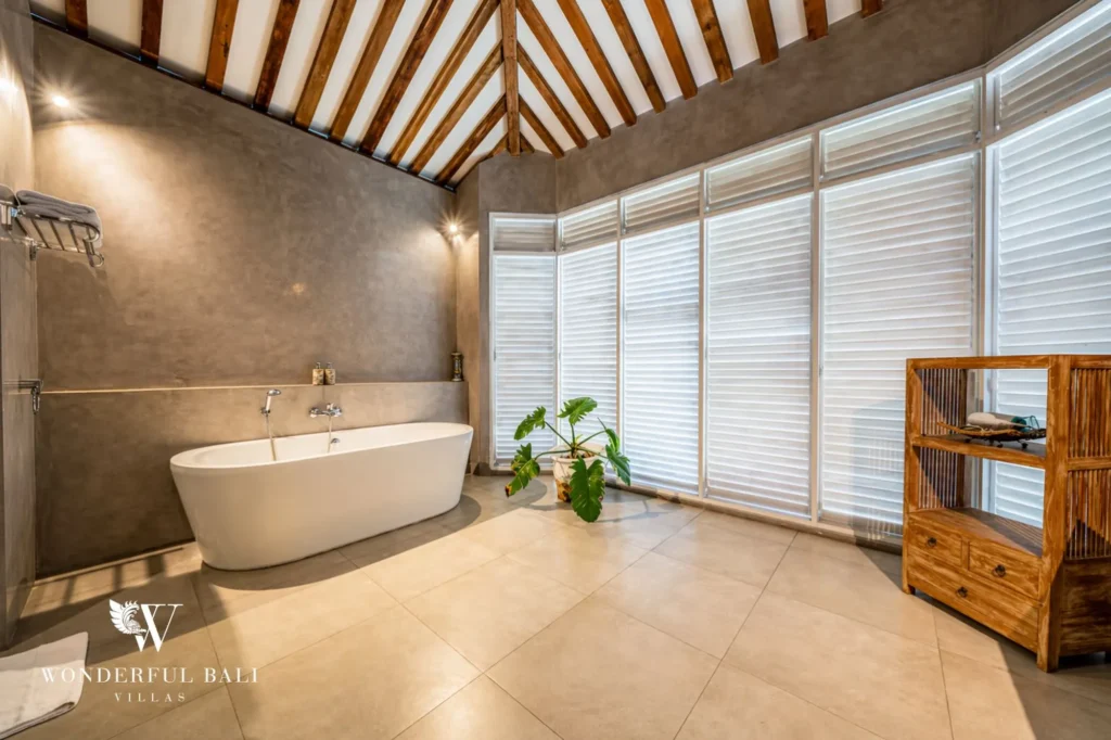 Spacious bathroom with freestanding bathtub under a vaulted timber ceiling, Villa Hasian in Jimbaran
