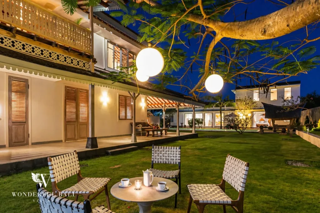 Garden at night lit by globe lanterns with seating by the veranda, Villa Hasian in Jimbaran