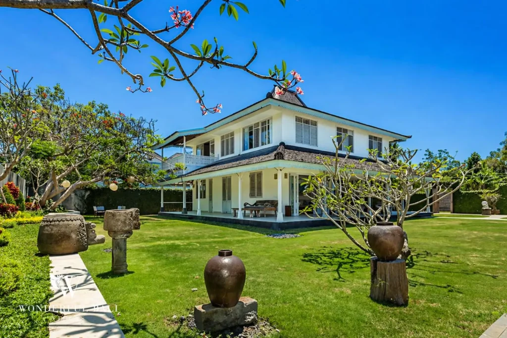 Two-storey villa with blossoming plumeria tree in the foreground, Villa Hasian in Jimbaran