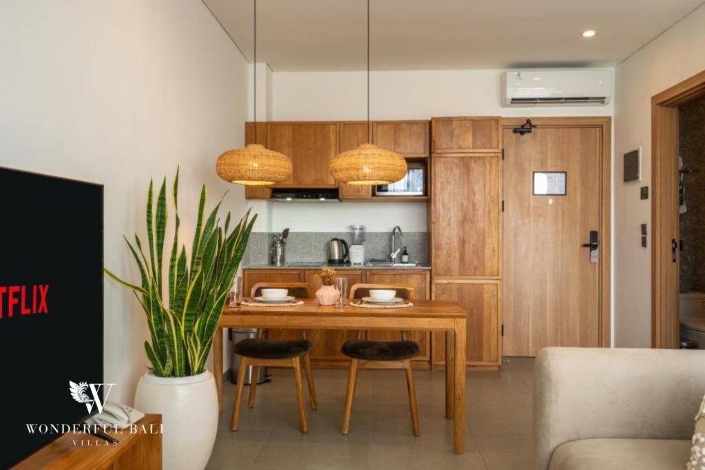 Dining table with pendant lights and equipped kitchenette, 1-bedroom studio apartment in Canggu