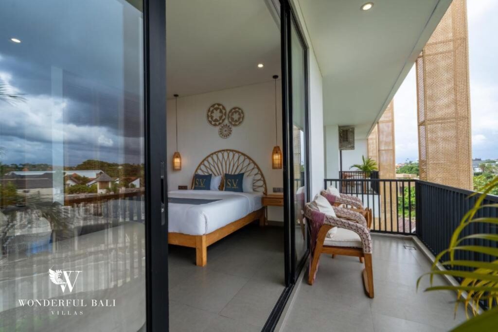 Bedroom opening onto private balcony with rooftop view, 1-bedroom studio apartment in Canggu