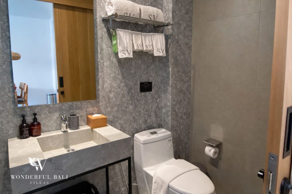 Bathroom with stone-look vanity and toilet, 1-bedroom studio apartment in Canggu