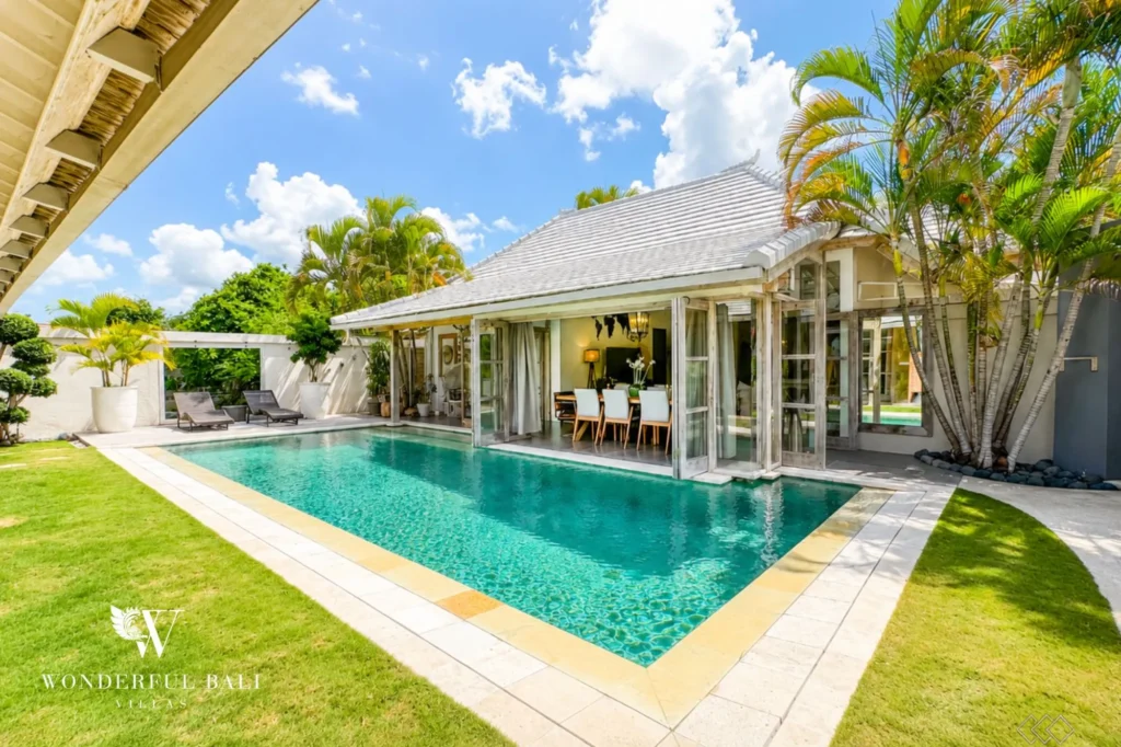 Private pool fronting a contemporary villa with traditional roof, 4-bedroom family villa in Mertasari, Kerobokan