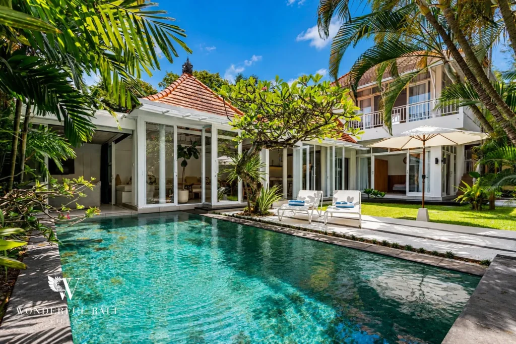 Private 25 m² pool fronting a modern white villa with traditional joglo roof, 4-bedroom family villa in Berawa, Canggu