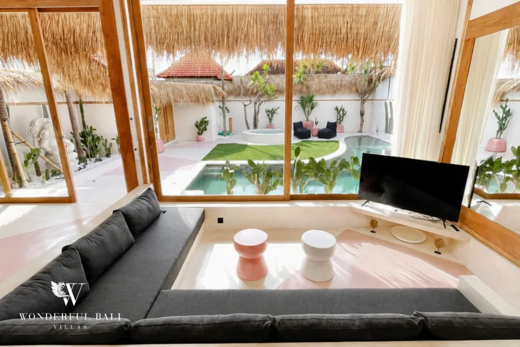 Sunken lounge with floor-to-ceiling windows facing pool and cactus garden in Berawa, Bali