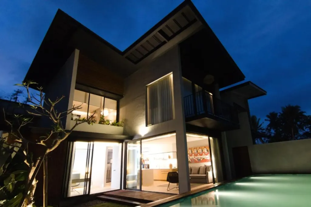 Villa Umahan, Ubud — exterior, two-storey villa lit from inside at twilight with private pool, Villa Umahan