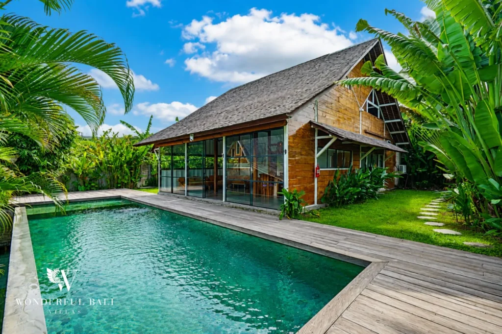 Overview of the large private pool and timber deck, 4-bedroom dual-villa compound in Pererenan
