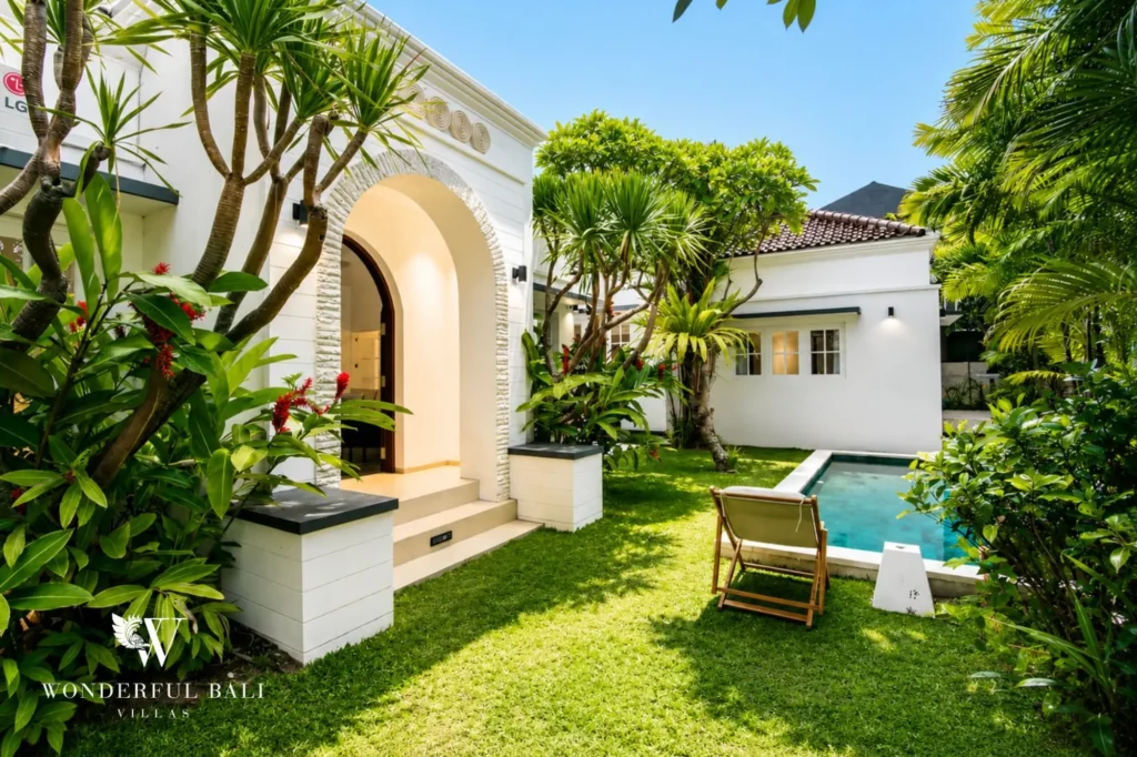 View of the villa from the garden side with mature planting, 3-bedroom colonial villa in Umalas