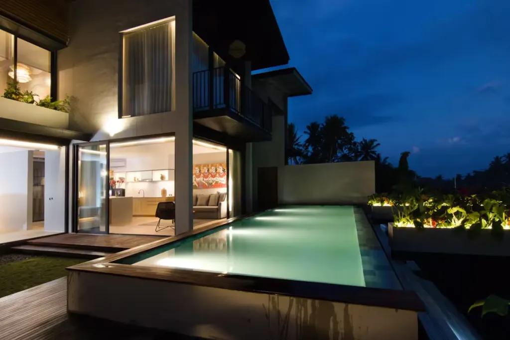 Villa Umahan, Ubud — pool, night with villa lit and jungle backdrop, Villa Umahan