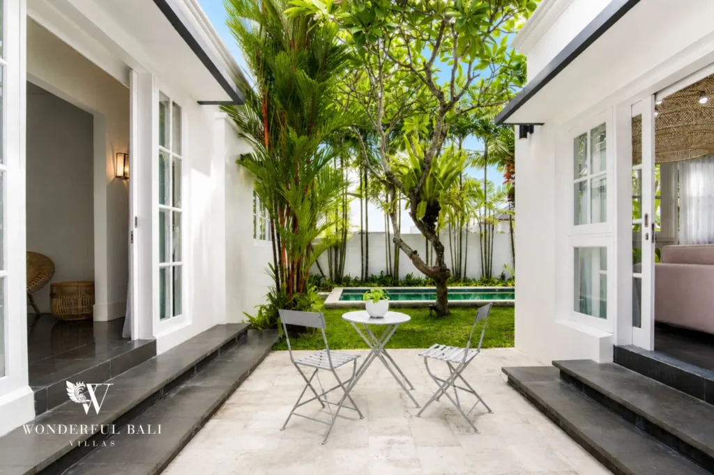 Courtyard and pool surrounded by colonial-style villa wings, 3-bedroom property in Umalas
