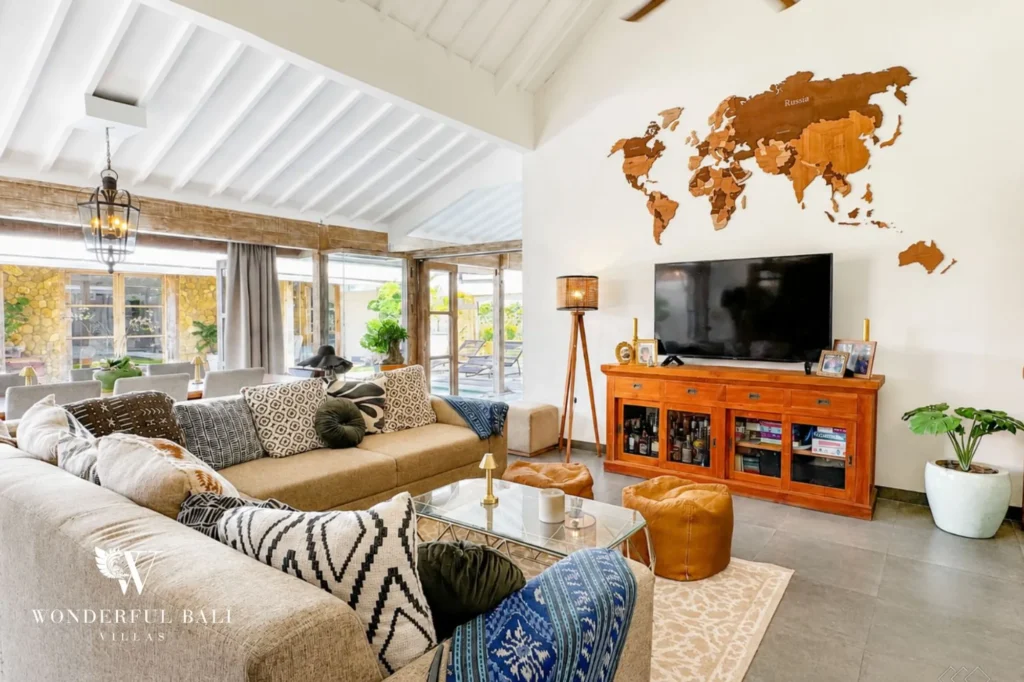 Living room with sofa and large world map art, 4-bedroom family villa in Mertasari, Kerobokan