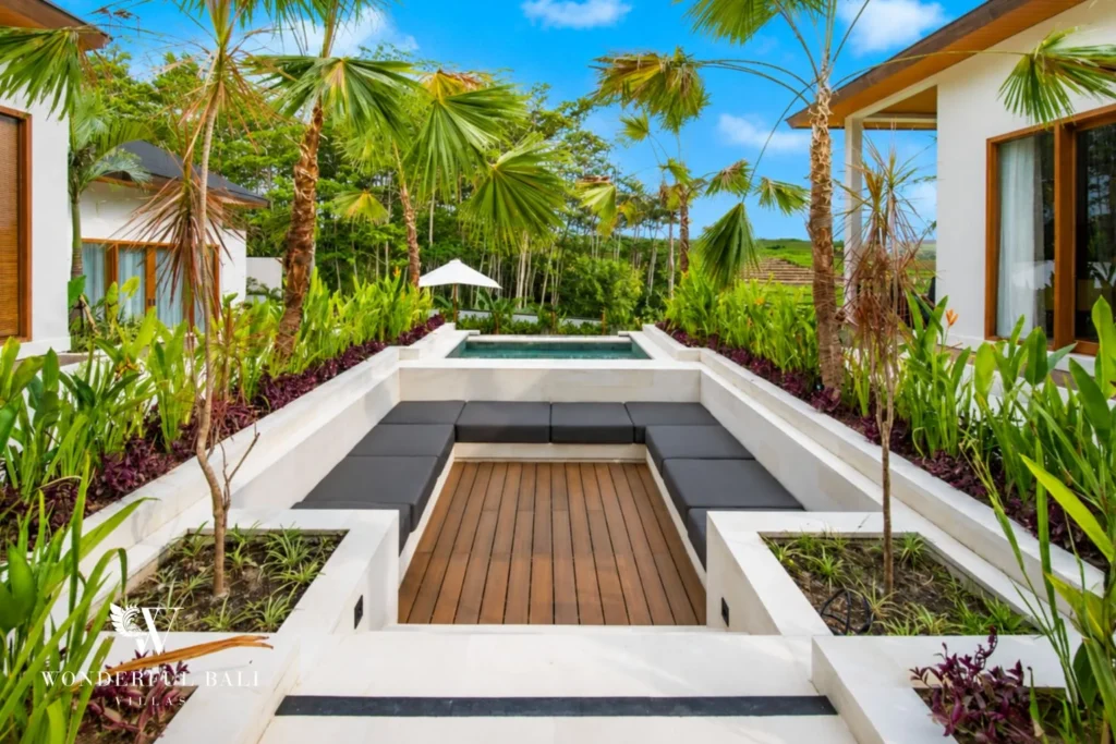 Outdoor sunken lounge with bench seating and tropical garden in Tumbak Bayuh, Bali