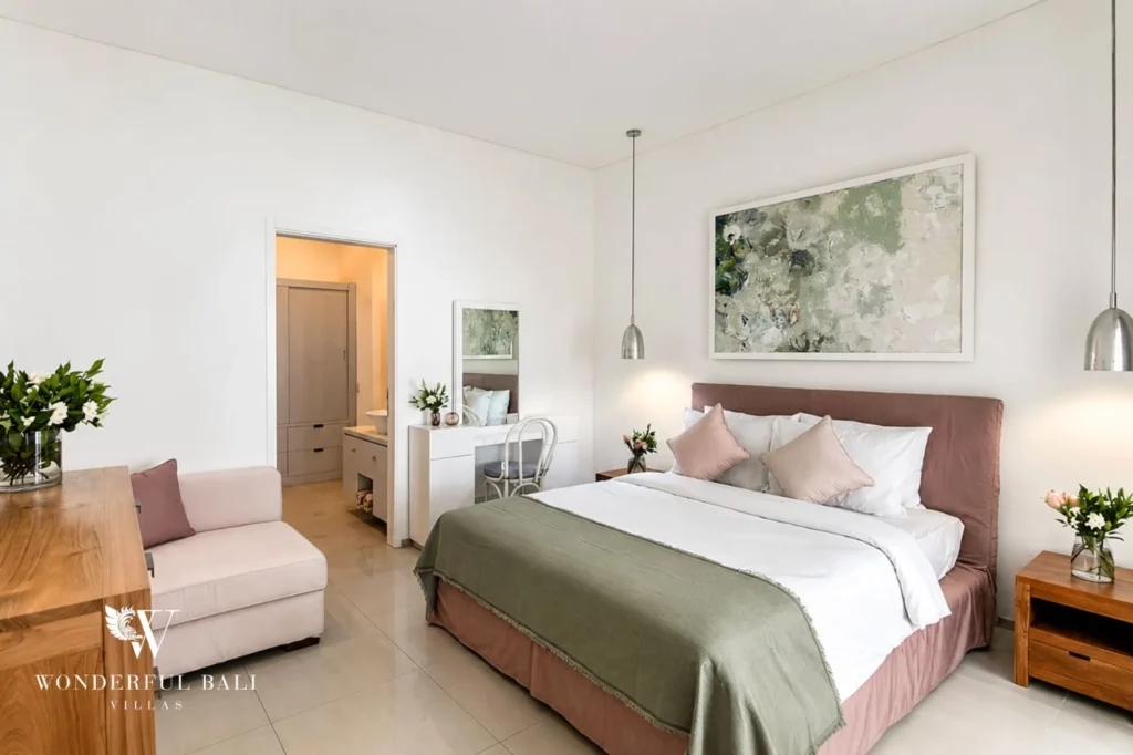Bedroom with crisp white linens and green throw, 3-bedroom colonial villa in Umalas