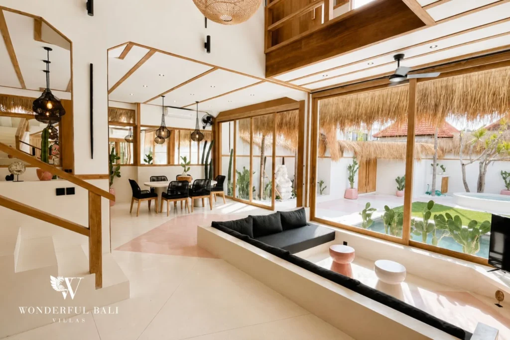 Open-plan living and dining with staircase and pool view in Berawa, Bali