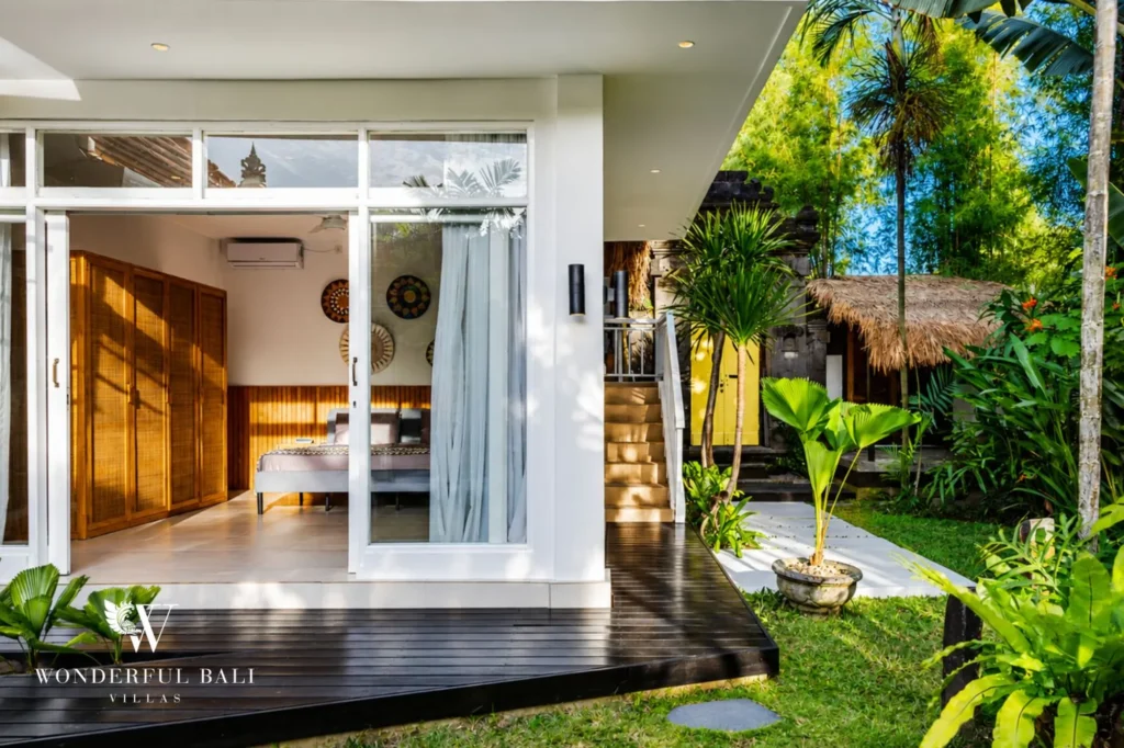 Bedroom opening to a private outdoor patio, 4-bedroom family villa in Berawa, Canggu