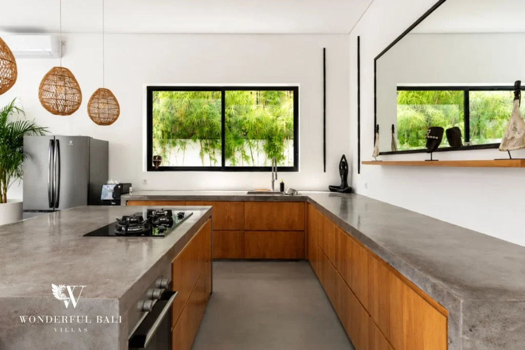 Kitchen detail with concrete worktops and timber cabinetry at Luxury 3BR Villa in Pererenan, Bali