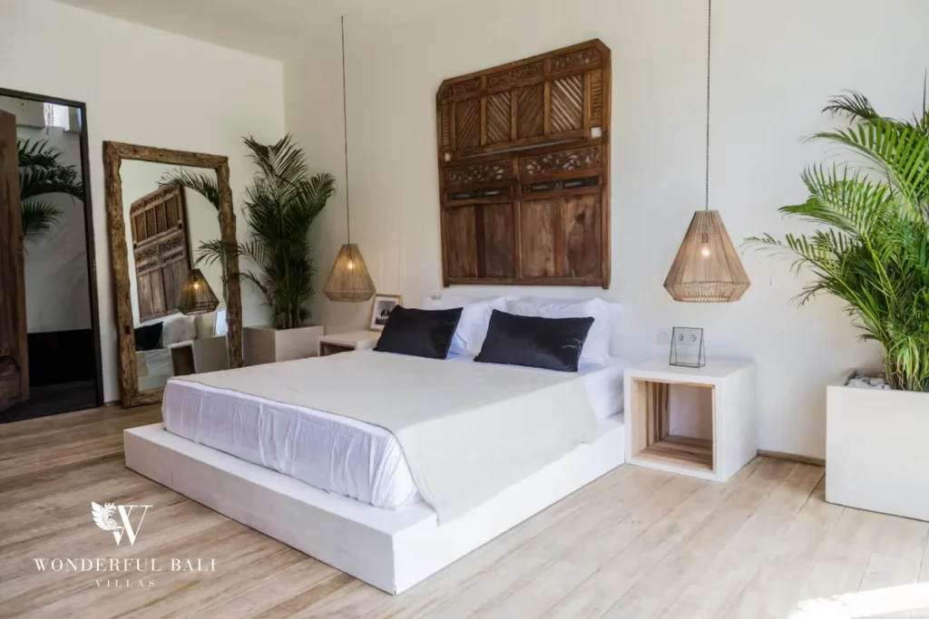 Master bedroom with carved wooden headboard and king bed in Umalas, Bali