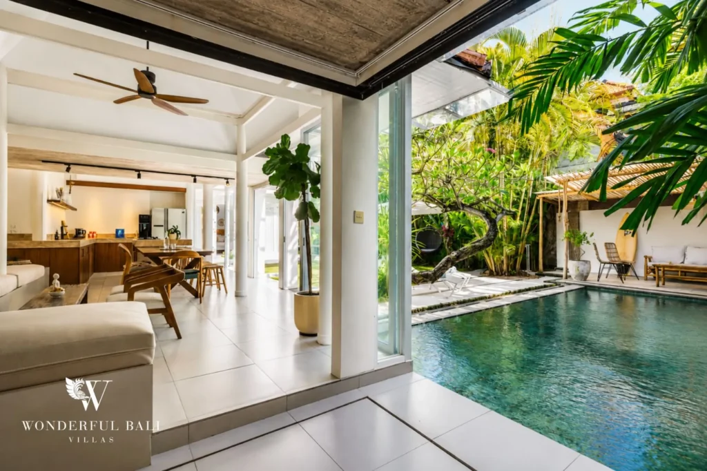 Open living area with sliding doors onto the pool deck, 4-bedroom family villa in Berawa, Canggu