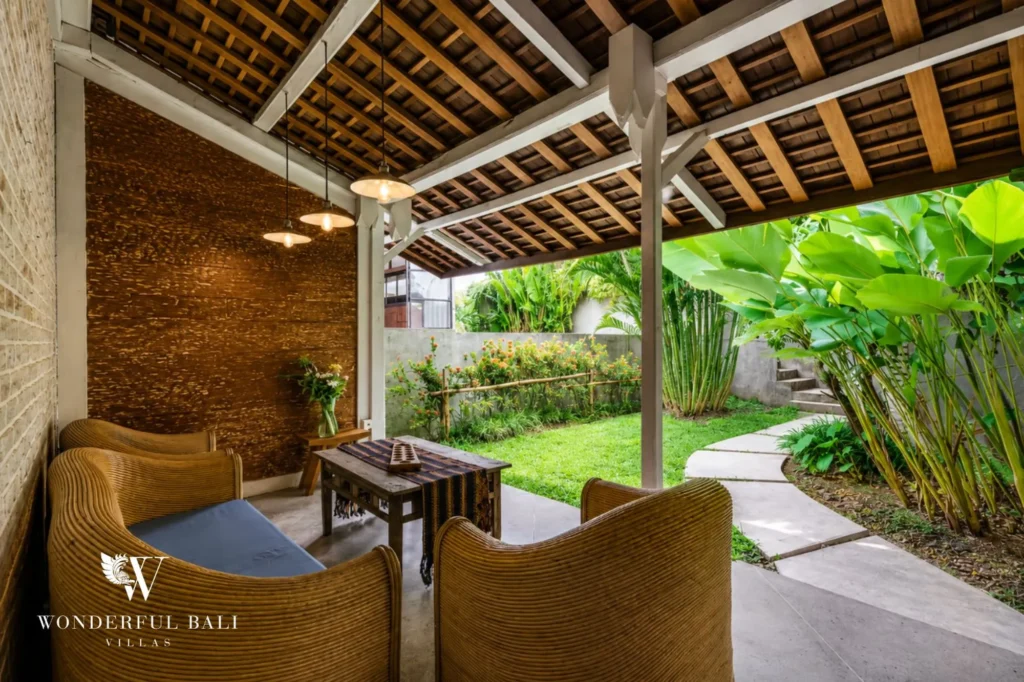 Double-height A-frame living room with cathedral timber ceiling and glass frontage, dual-villa compound in Pererenan