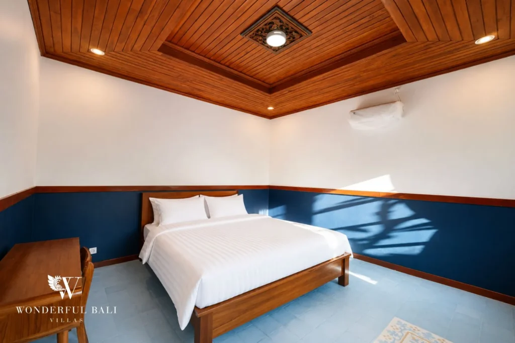 Master bedroom with blue accent wall, 2-bedroom Balinese modern villa in Sanur
